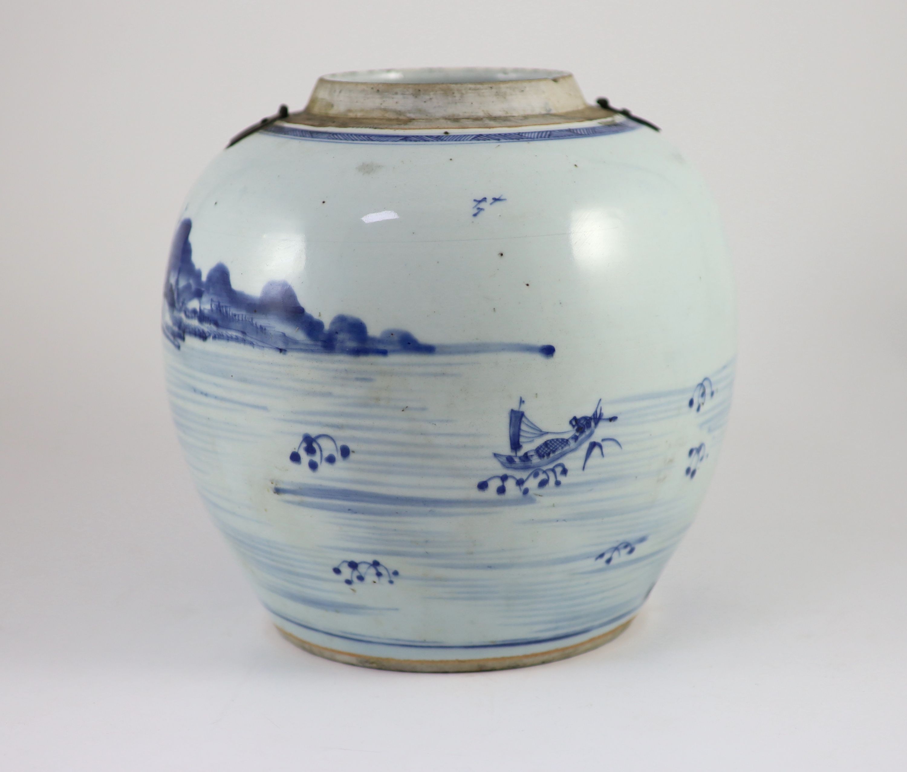 A Chinese blue and white jar and cover, Kangxi period (1662-1722), 23cm high, metal fittings attached to shoulder, Cover repaired and not the best fit